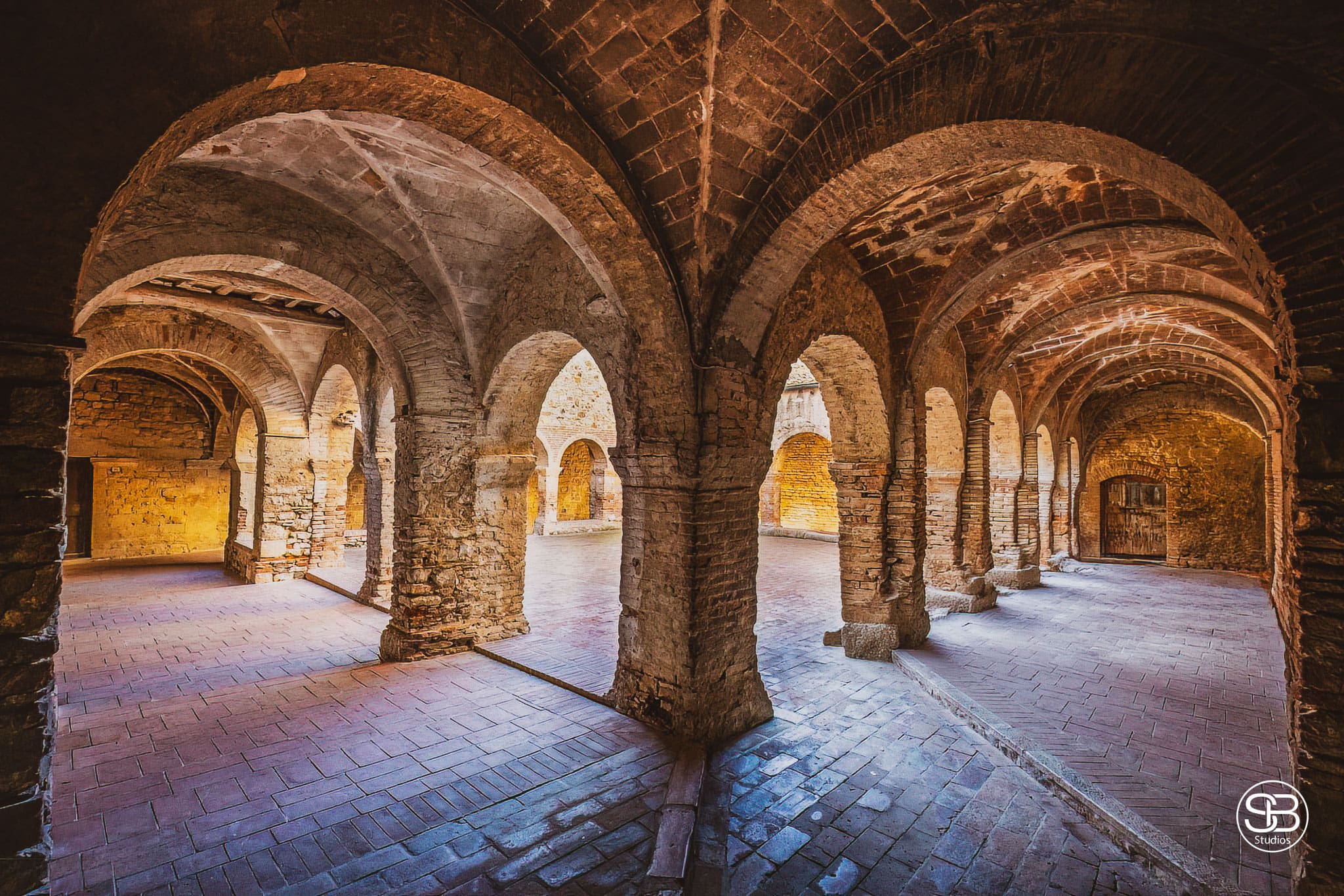 Cloister-of-Saint-Francis-in-Cisterna-Square,-nestled-in-the-medieval-village-of-Suvereto,-Province-of-Livorno,-Tuscany,-Italy-by-SB-Studios-2024